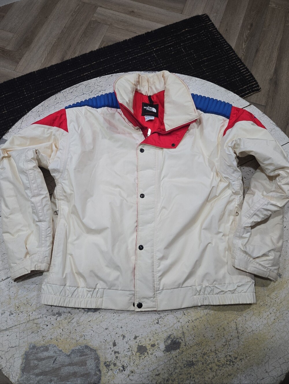 The North Face Men’s Cream Ski Jacket with Red & Blue Accents